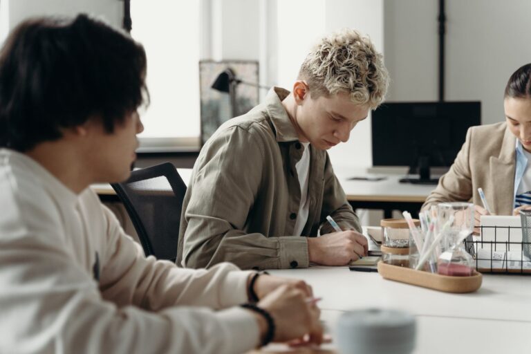 Young professionals taking notes at a desk